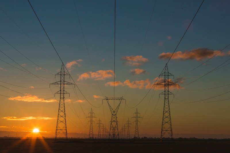 Electricity pylons carrying power at sunset